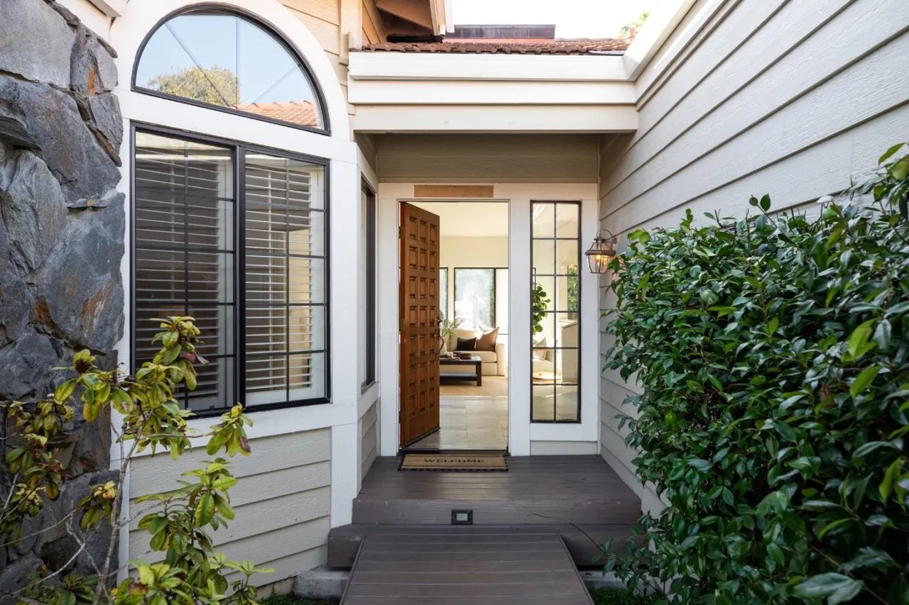 A tidy home entrance with an open front door